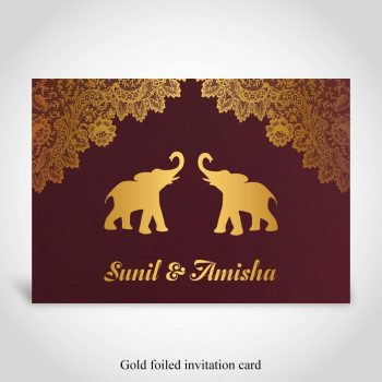 Dark red Hindu wedding card with gold foiled elephant and bride and grooms names