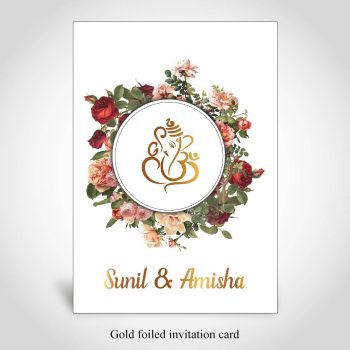 Floral Hindu wedding card with gold foiled Ganesh and names of couple.