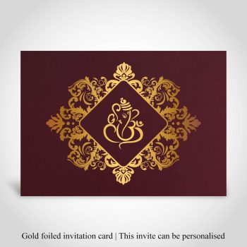 Exquisite Hindu wedding invitation with a gold-foiled Ganeshji in an ornate frame, symbolizing prosperity and divine blessings.